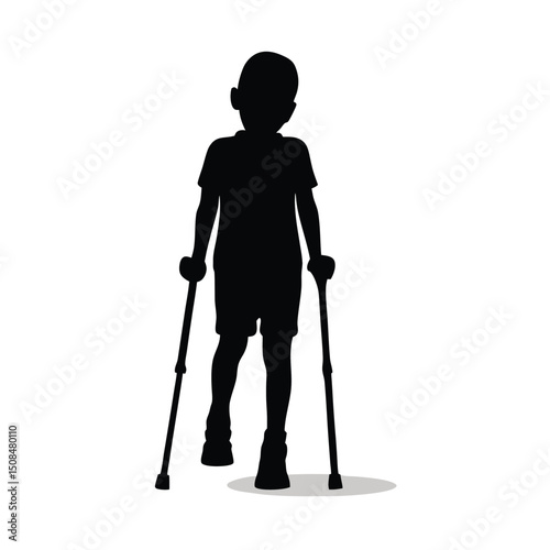 Young boy walking with crutches silhouette.