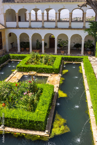 Fountains and boxwood hedges decorating the gardens of the Generalife Palace in Granada, Spain photo