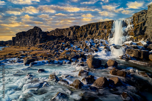 Oxararfoss waterfall at Thingvellir national park in Iceland with clear blue sky in day time for travel destination.