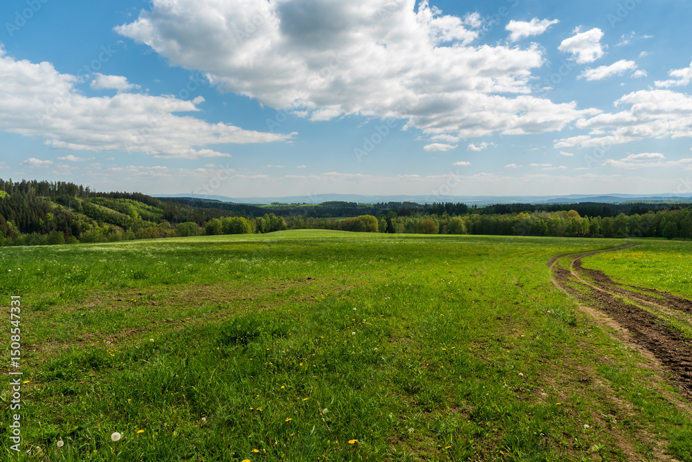 Fototapeta premium Springtime rolling landscape near Vysoky kamen hill in Krusne hory mountains