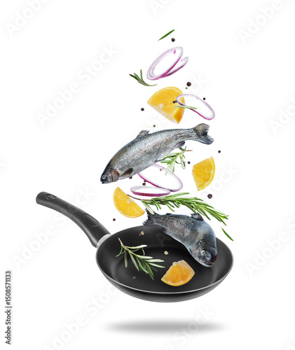 Sea trout with rosemary branches and lemon slices falling into frying pan on white background