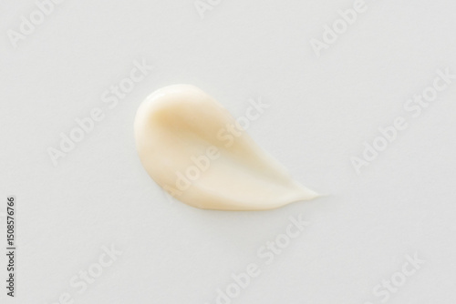 Beige cream smear on white background cosmetic skincare texture, minimalist close-up. Moisturizer, lotion, serum, shampoo, hair conditioner or foundation
