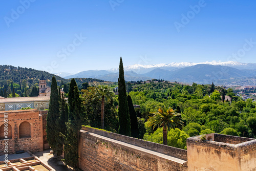 View of the Sierra Nevada from a tower of the Alhambra in Granada, in springtime with blue sky.