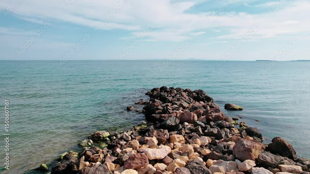 Coastline landscape, first person view of the sea, stones and rocks, video background.