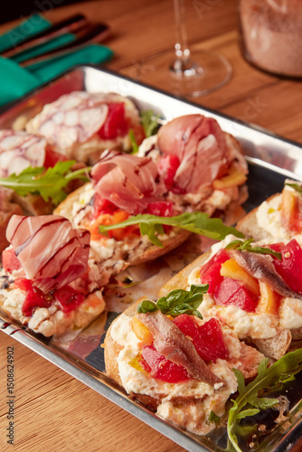 Assorted Italian bruschetta served on rustic bread with toppings like octopus, cured meats, ricotta, tomatoes, and anchovies, close-up view.
