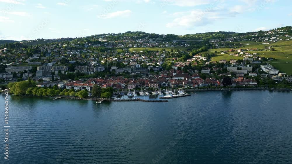 Aerial: Lutry cityscape at sunset in Lavaux with Lake Geneva in canton of Vaud, Switzerland, establishing drone shot Aerial: Lutry cityscape at sunset in Lavaux with Lake Geneva in canton of Vaud, Switzerland, establishing drone shot