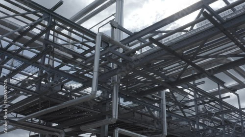 Wallpaper Mural Low angle shot looking up at a dense and complex network of industrial pipes and steel support structures against a cloudy sky, Castets, France Torontodigital.ca
