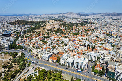 Aerial view of Plaka and the Acropolis in Athens, where ancient history meets a vibrant cityscape under the clear Mediterranean sky.