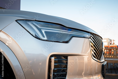 Cuadro en lienzo Front of a modern car with highlights including the sophisticated LED headlight design and the chrome front grille