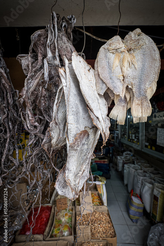 Great view of dried and salted octopus and fish hanging from the ceiling of a grocery store next to the fish market in Port Louis, Mauritius, Africa