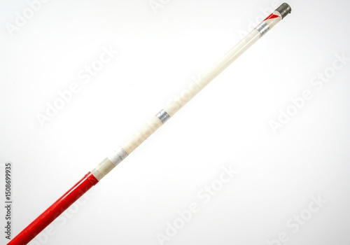 Long, white-and-red pole with silver bands photo