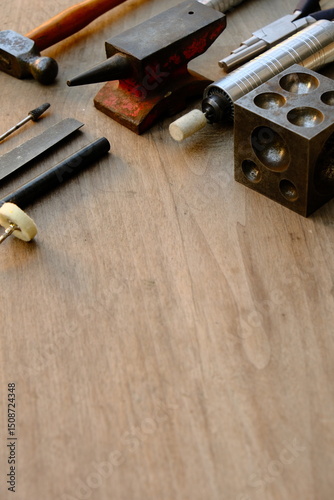 Jeweler's workplace. Top view of jeweler's workbenche with different tools on a wooden table. Goldsmith concept background