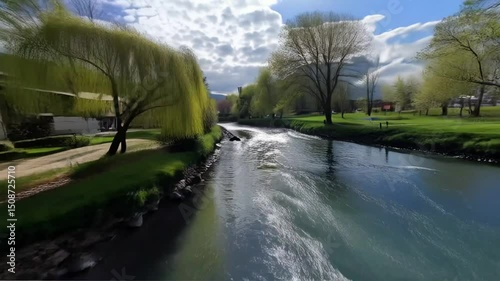 Flowing River Rushing Through Peaceful Town in Spring