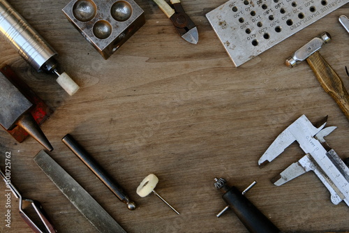 Jeweler's workplace. Top view of jeweler's workbenche with different tools on a wooden table. Goldsmith concept background