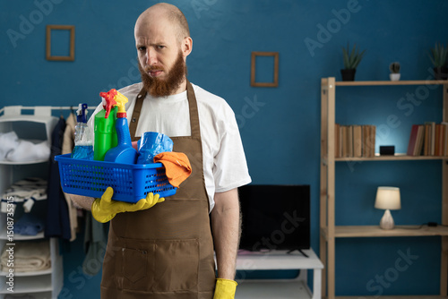 offended house cleaner looking at camera with sad expression photo