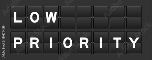 Black color analog flip board with word low priority on gray background