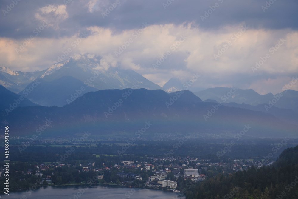Fototapeta premium panorama of the mountains with rainbow after the rain and cloudy mood