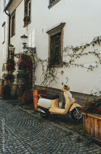 Fototapeta Naklejka Na Ścianę i Meble -  narrow street in old town with small scooter parked