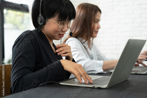 A visually impaired woman collaborates seamlessly with her colleagues, proving that teamwork and inclusion empower everyone to contribute equally in a professional environment.