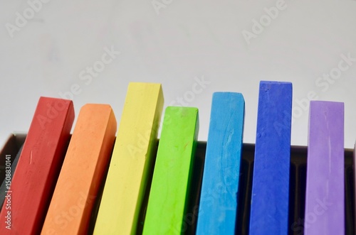 Multicolor soft pastels, crayons, pencils in a box. Variety of colors, art supplies for drawing and sketching. 