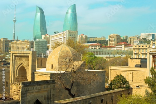 Baku city, Azerbaijan, view of historic mosques and walls of the Shirvanshahs Palace in the Old City and modern glass Flame Towers