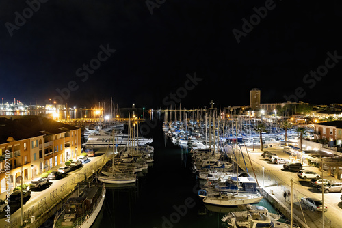 Marina with sailing ships of Port de Bouc at night with reflections and lighting in spring in France