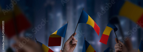 Chad flags in their hands on a blurred urban background