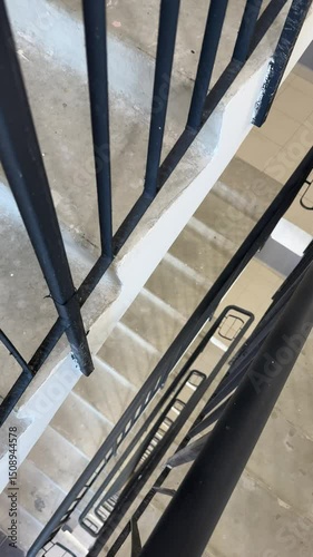staircase landing in a residential building entrance. Concrete stairs with metal railings, neutral lighting. Suitable for themes of urban life, housing, social projects, renovation, and architectural 