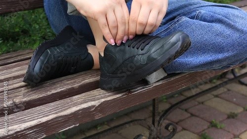 girl reconciles new shoes buying clothes from an online store genuine leather sneakers sneakers black