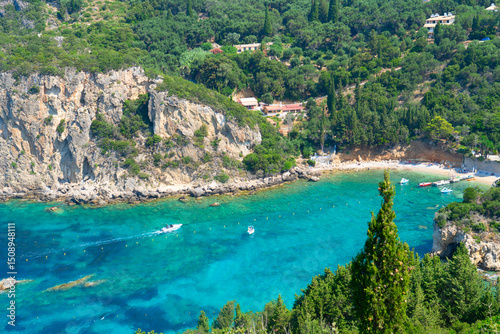 Fototapeta Naklejka Na Ścianę i Meble -  Paleokastritsa beach bay with sunbeds and Ionian sea clear water on Korfu, Greece