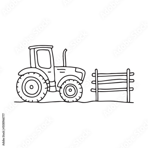 A tractor resting beside a wooden fence photo