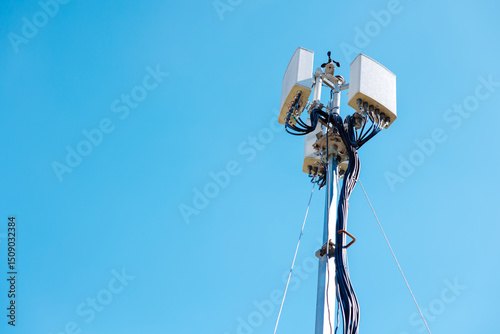 omni setup outdoor wifi, wireless internet network access point tower, 5G antenna against clear blue sky