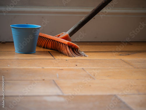 Spring cleaning sweeping room with a broom and bucket
