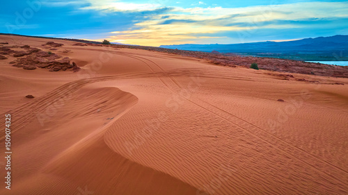 Aerial Sand Dunes and Red Rocks with Tire Tracks at Sand Hollow State Park Utah photo