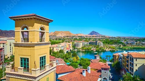Aerial Mediterranean Village Tower and Lake Oasis in Desert Setting