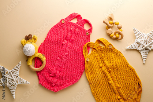 knitted baby romper and accessories on neutral fabric background flatlay newborn outfit