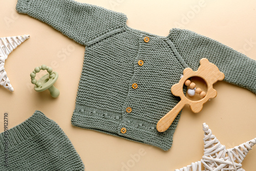 knitted baby romper and accessories on neutral fabric background flatlay newborn outfit