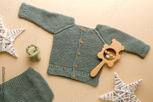 knitted baby romper and accessories on neutral fabric background flatlay newborn outfit