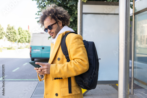 Casual urban style of an afro man with smartphone