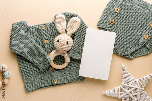 Newborn baby clothes mockup featuring hand-knitted, soft, and cozy babywear flatlay with a minimalist infant outfit