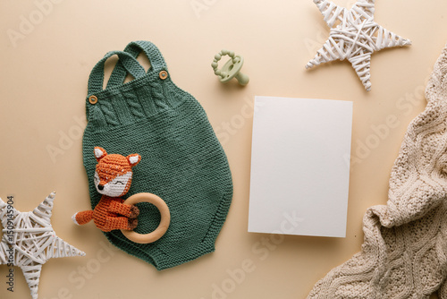 Newborn baby clothes mockup featuring hand-knitted, soft, and cozy babywear flatlay with a minimalist infant outfit