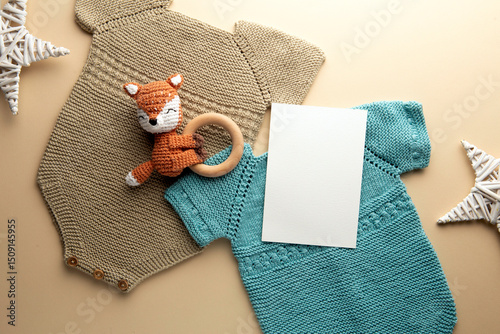 Newborn baby clothes mockup featuring hand-knitted, soft, and cozy babywear flatlay with a minimalist infant outfit