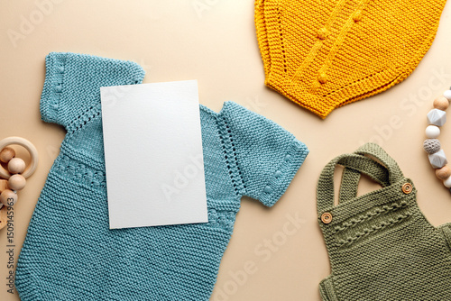 Newborn baby clothes mockup featuring hand-knitted, soft, and cozy babywear flatlay with a minimalist infant outfit