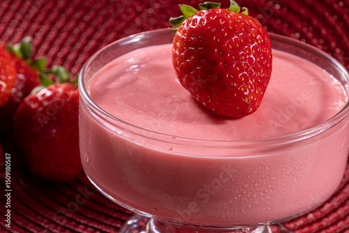Tasty strawberry mousse in glass with strawberry on top