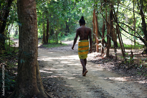 Vedda tribesman of Sri Lanka stands in natural surroundings, representing indigenous culture, traditional lifestyle, and connection to nature. Tribal portrait in native Habitat. 02.03.2022 SRI LANKA