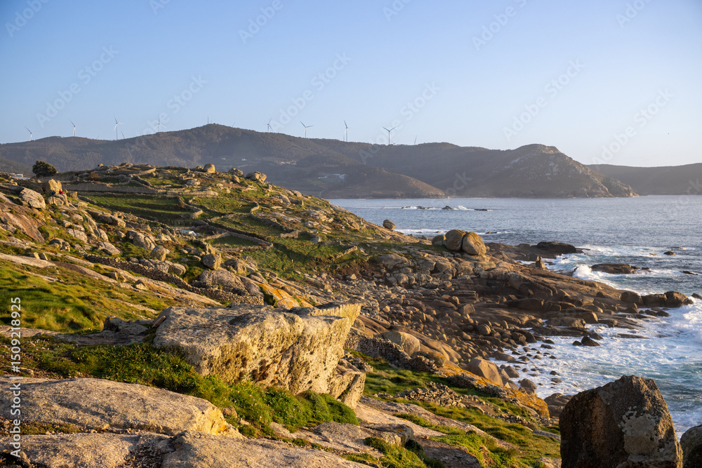 Fototapeta premium Wild coastal cliffs by the Muxía Lighthouse, A Coruña, Galicia, Spain. Known for fierce storms and shipwreck legends along the 