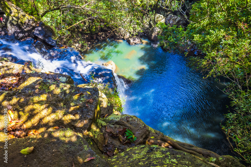 Beautiful view from the top of the Tamarind waterfalls, also known as the Seven Cascades in Mauritius, looking down at the turquoise-colored pond
