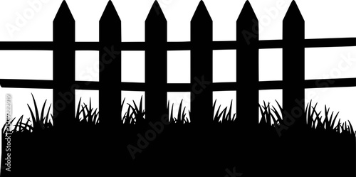Silhouette of a wooden fence and grass