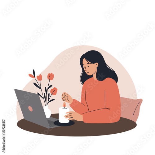 Young woman working on laptop while enjoying a candle and flowers  