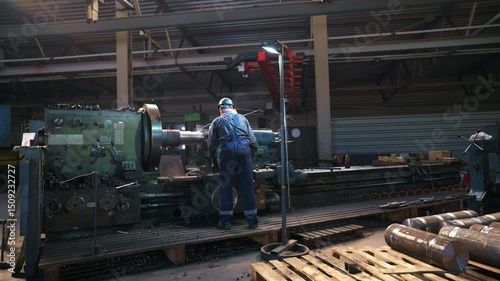 Industrial Worker Skillfully Operating Heavy Machinery in a Factory Setting with Precision